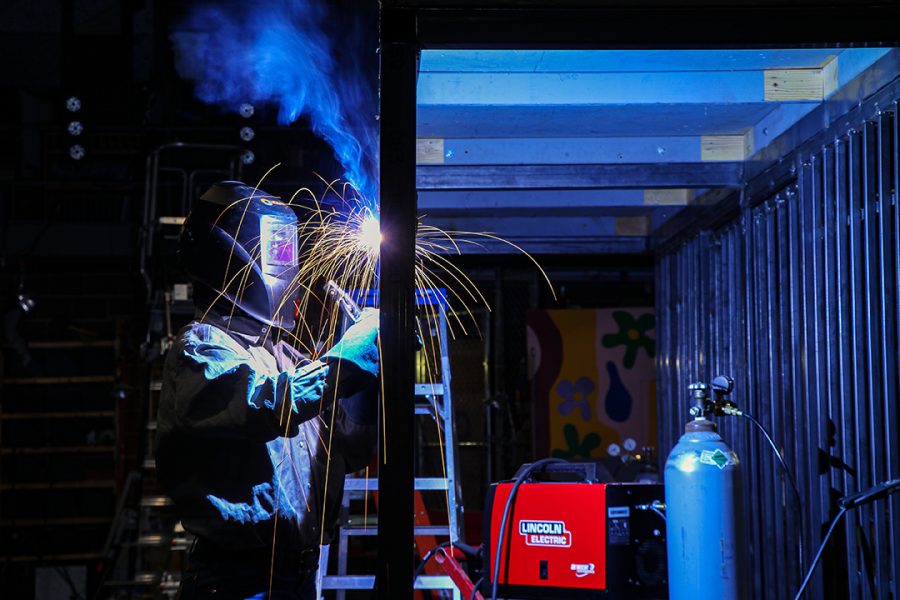 During an after school workshop, senior Wyatt Lanphear welds pieces of metal together to prepare the set for the musical "Chicago: High School Edition.” The musical opens Feb. 25.