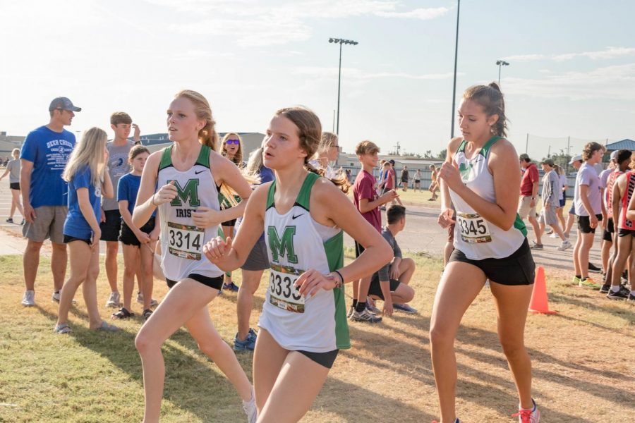 Senior Kate Skarky, and sophomores Emery Atchison and Margot Knudtson heads to the finish line.