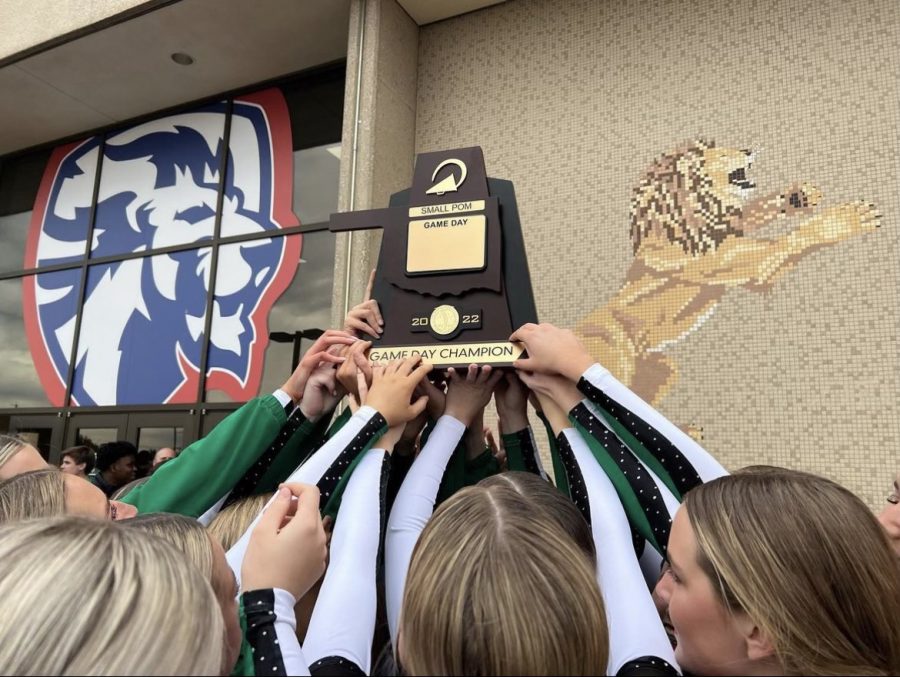 Pom+hoists+trophy+after+win+at+Game+Day+State.