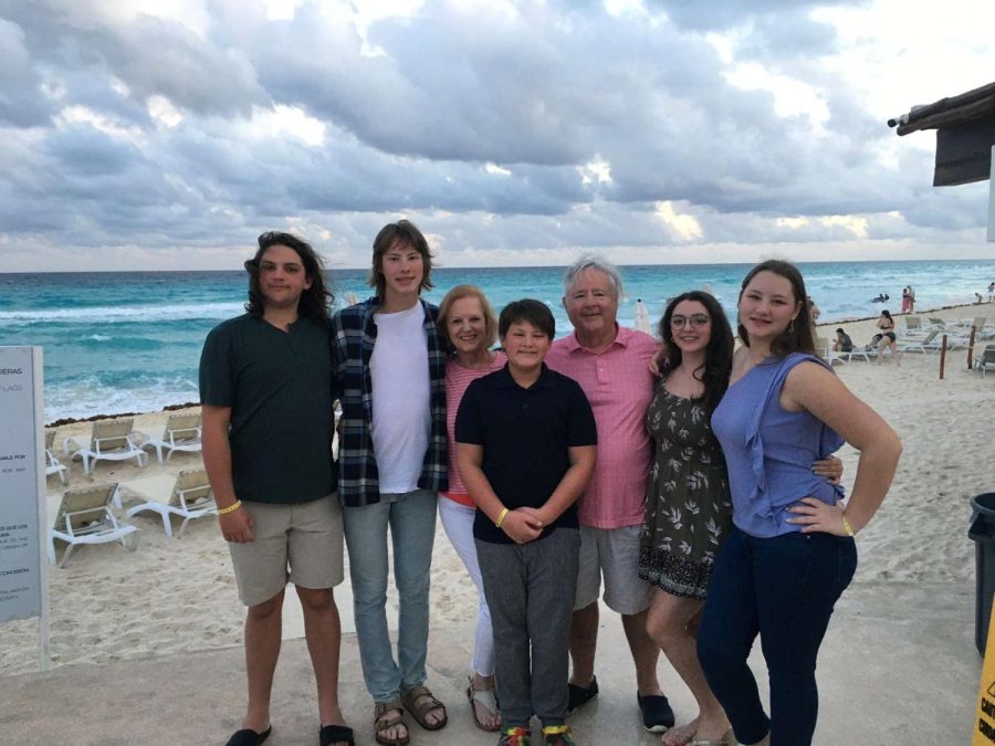 Chamber poses for photo on the beach with her family.