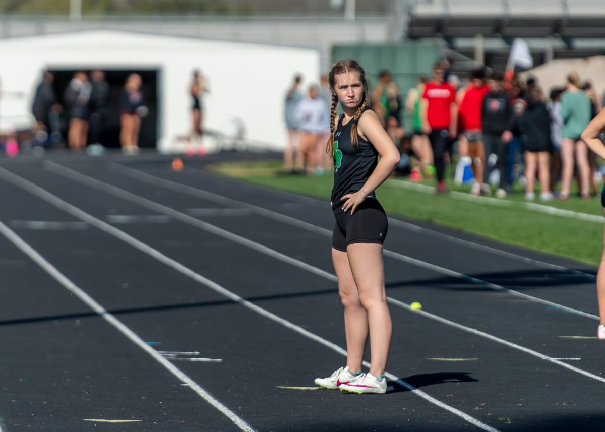 Freshman Charlotte Ozan takes the track, while she waits to run the 400 meter relay. The team finished with a time of 57.29.
