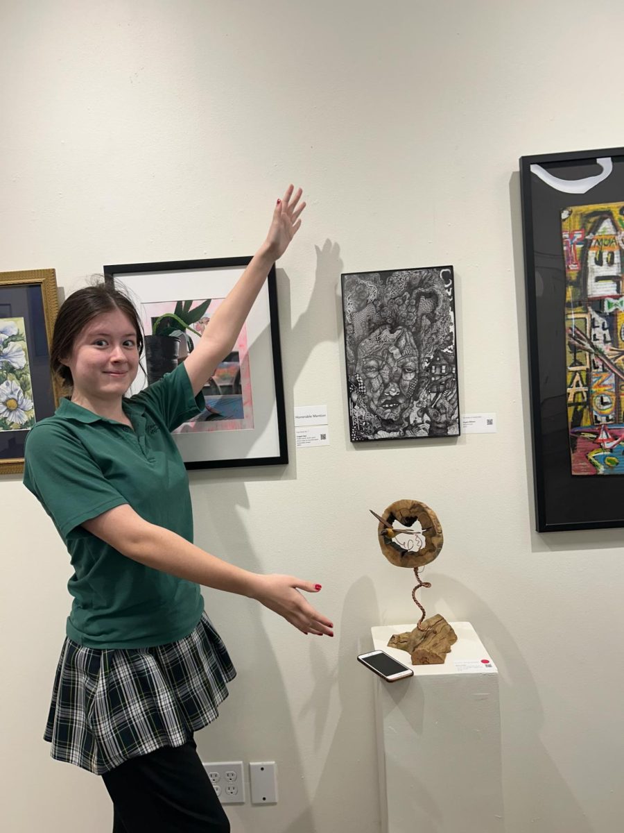 Sophomore Angela Williams in front of her art piece titled “Bride of Frankenstein.” Photo by Kate Menz
