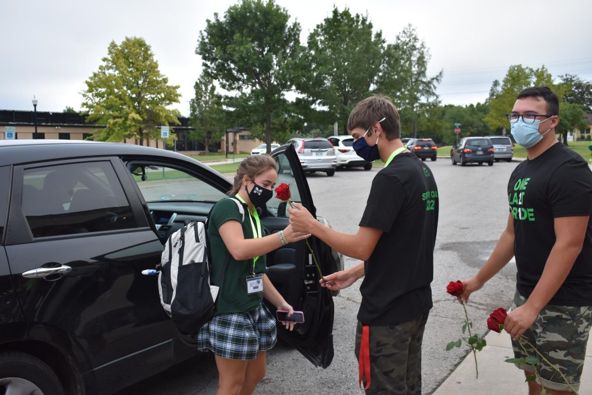 Class of 2024 during their freshman year of 2021. The freshman received roses from the seniors as they entered into the first day of high school.