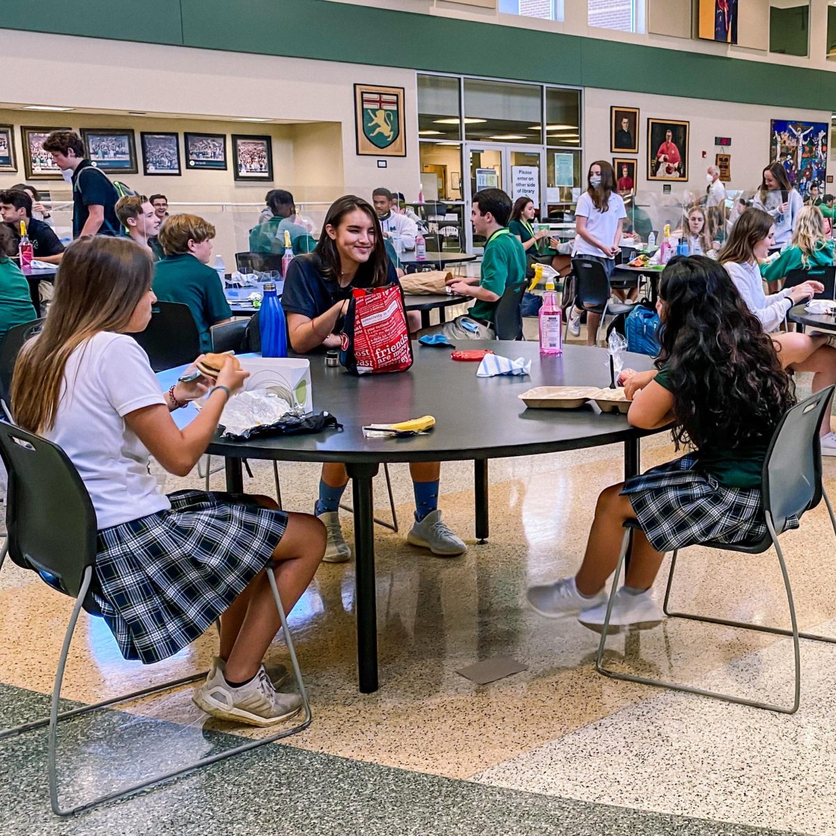 School has lunch with Covid restrictions. Lunch was restricted to three people per table, with some divided with plexiglass. Photo courtesy of Advancement.