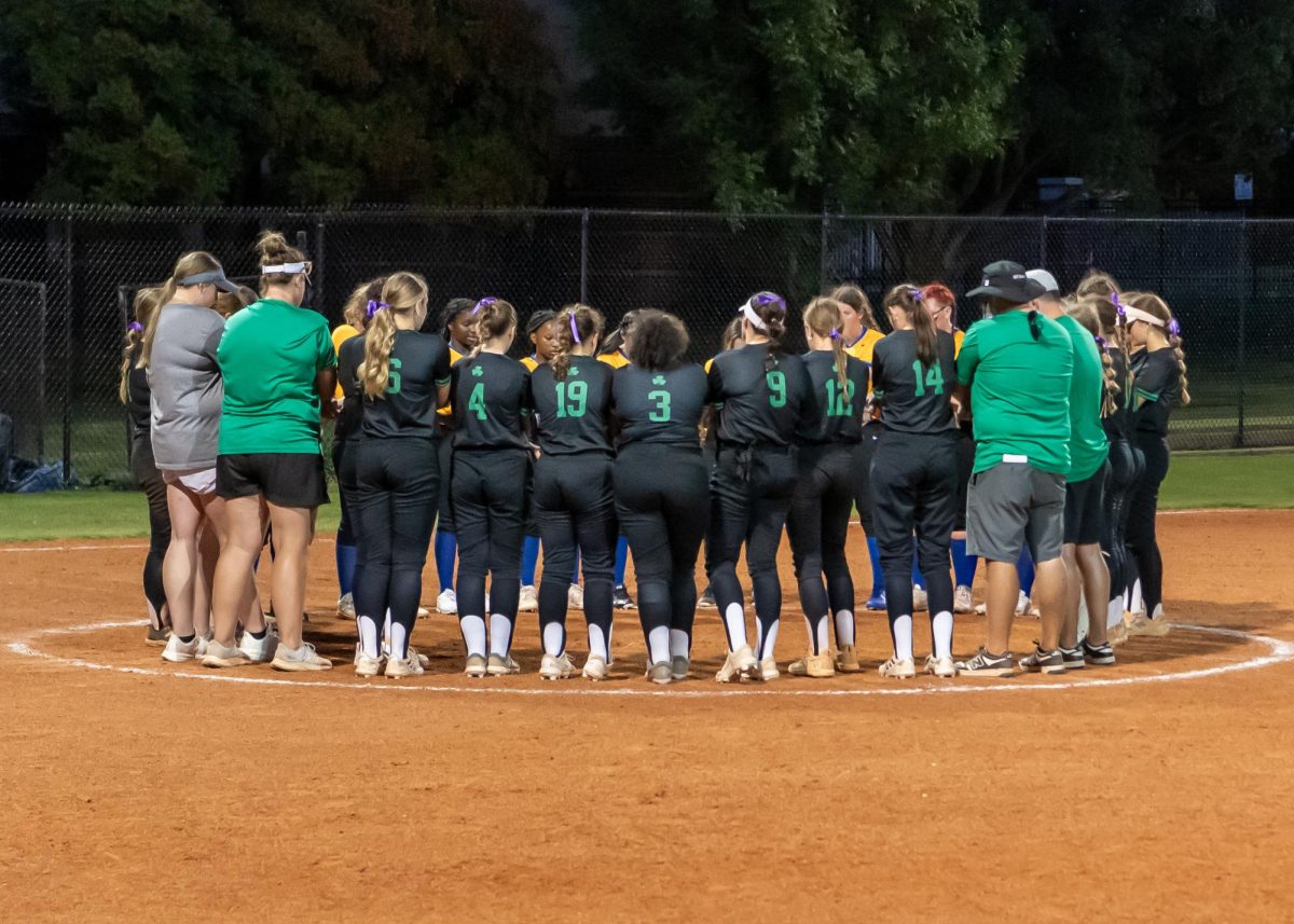 The Lady Irish praying with the Comets after the Classen SAS game. 