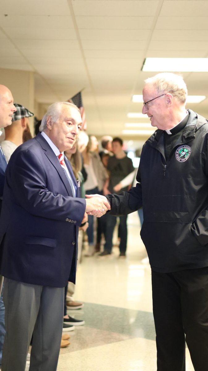 President Rick Stansberry shakes the hand of a veteran to show appreciation for his service to the country.  