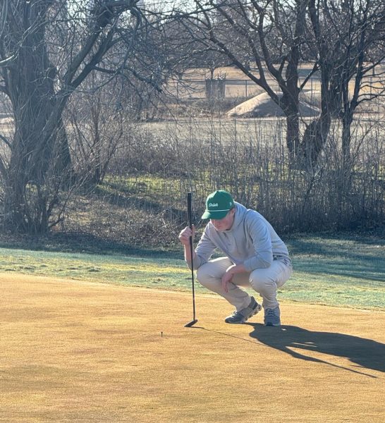 Junior Corbin Sanders prepares for his next putt. Photo courtesy of Matt Loporto