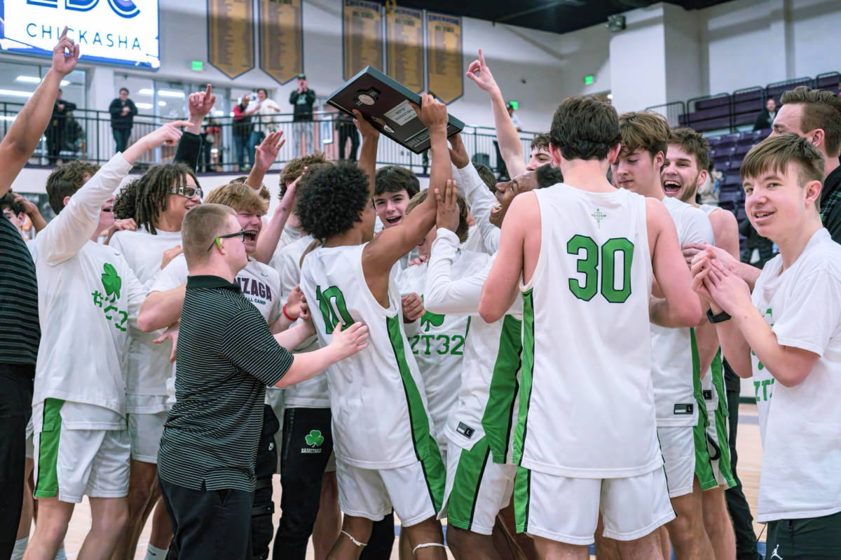 After a nail-biting 35-34 victory over Idabel at the area qualifier in Chickasha. The boys basketball team celebrates their hard-fought win with their plaque, and punches their ticket to state. Photo by Aimee Martinez
