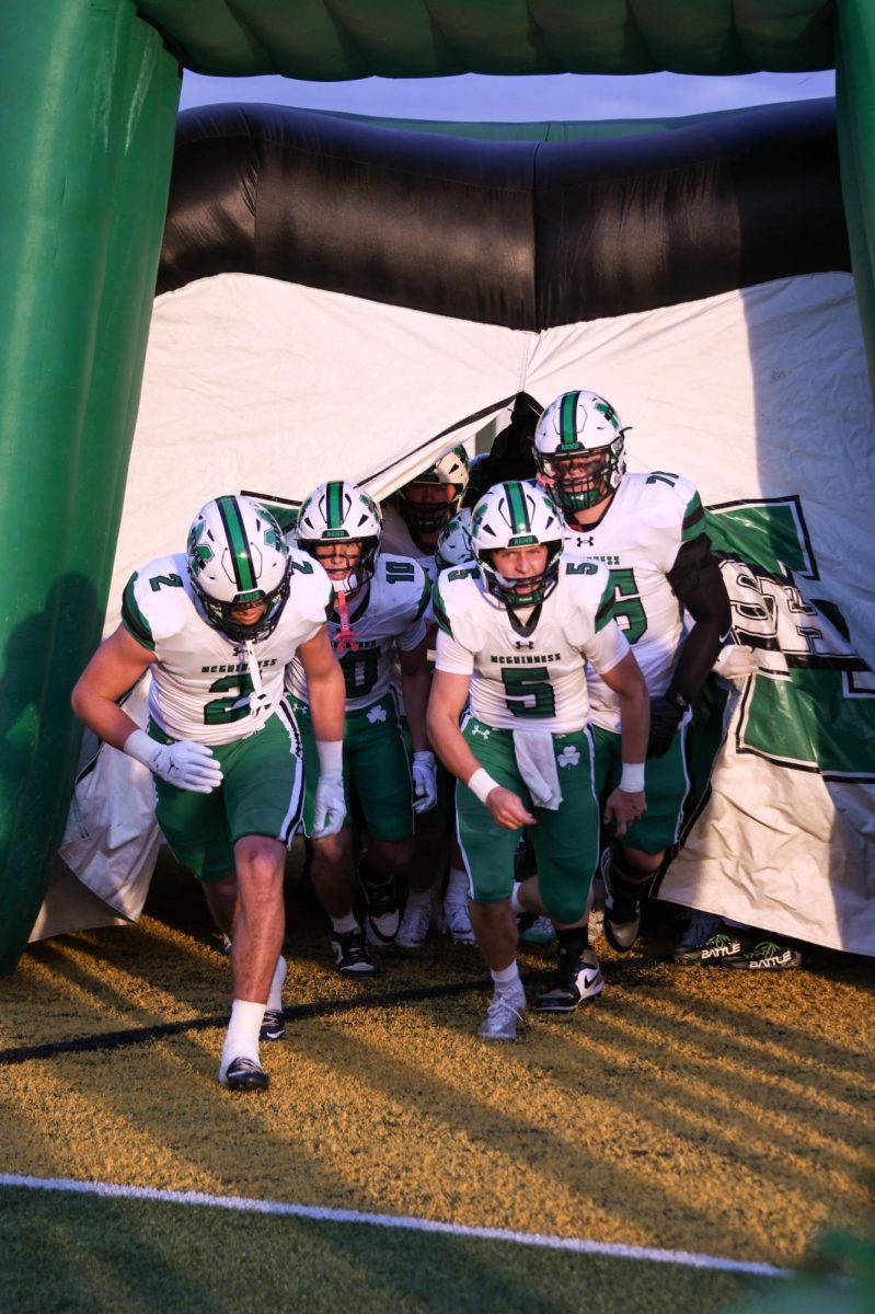 Football storms field before game against Bishop Carroll.