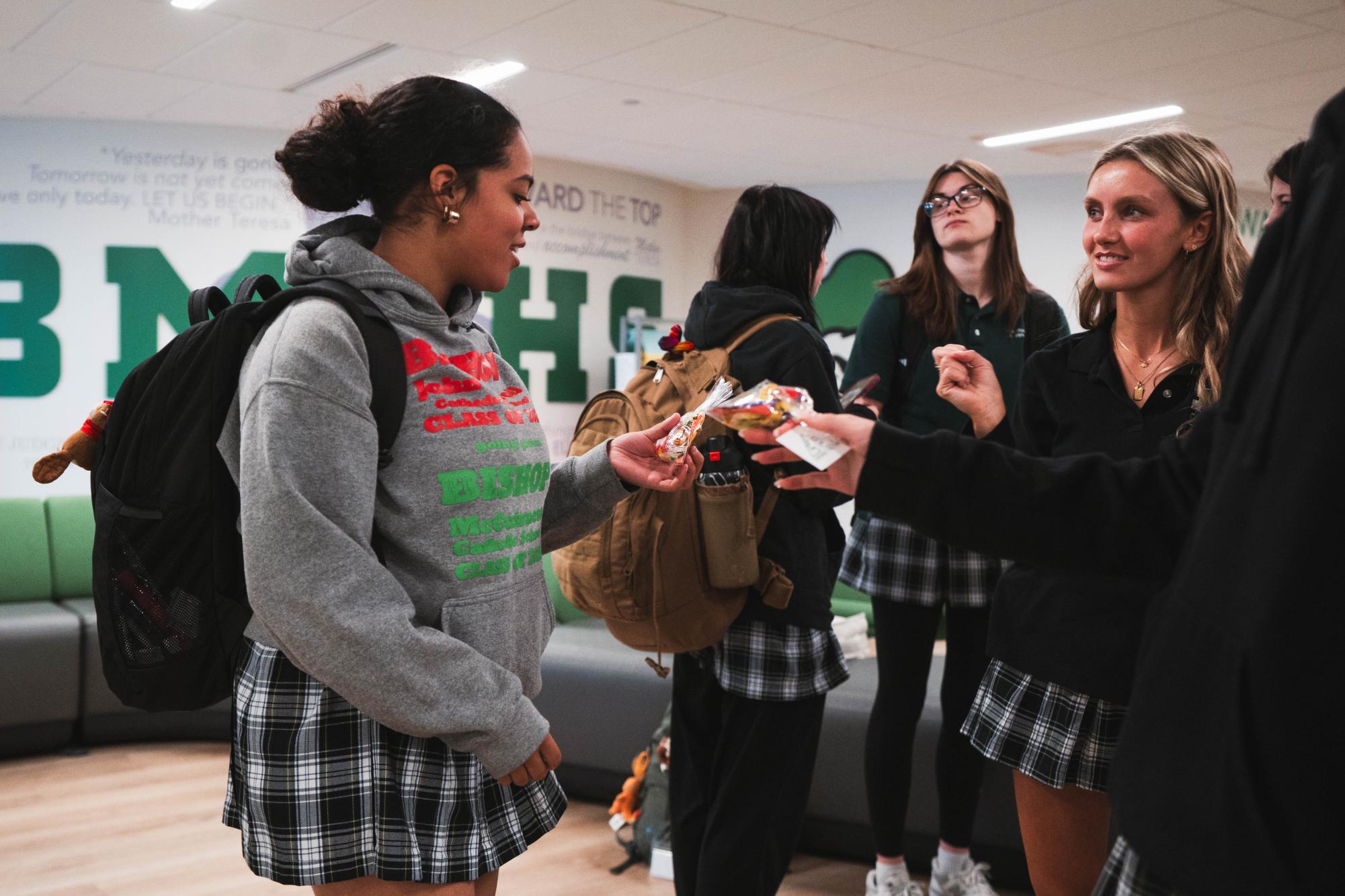Senior Charity Pina is given a candy bag in celebration of Saint Pier Giorgio Frassati's canonization.