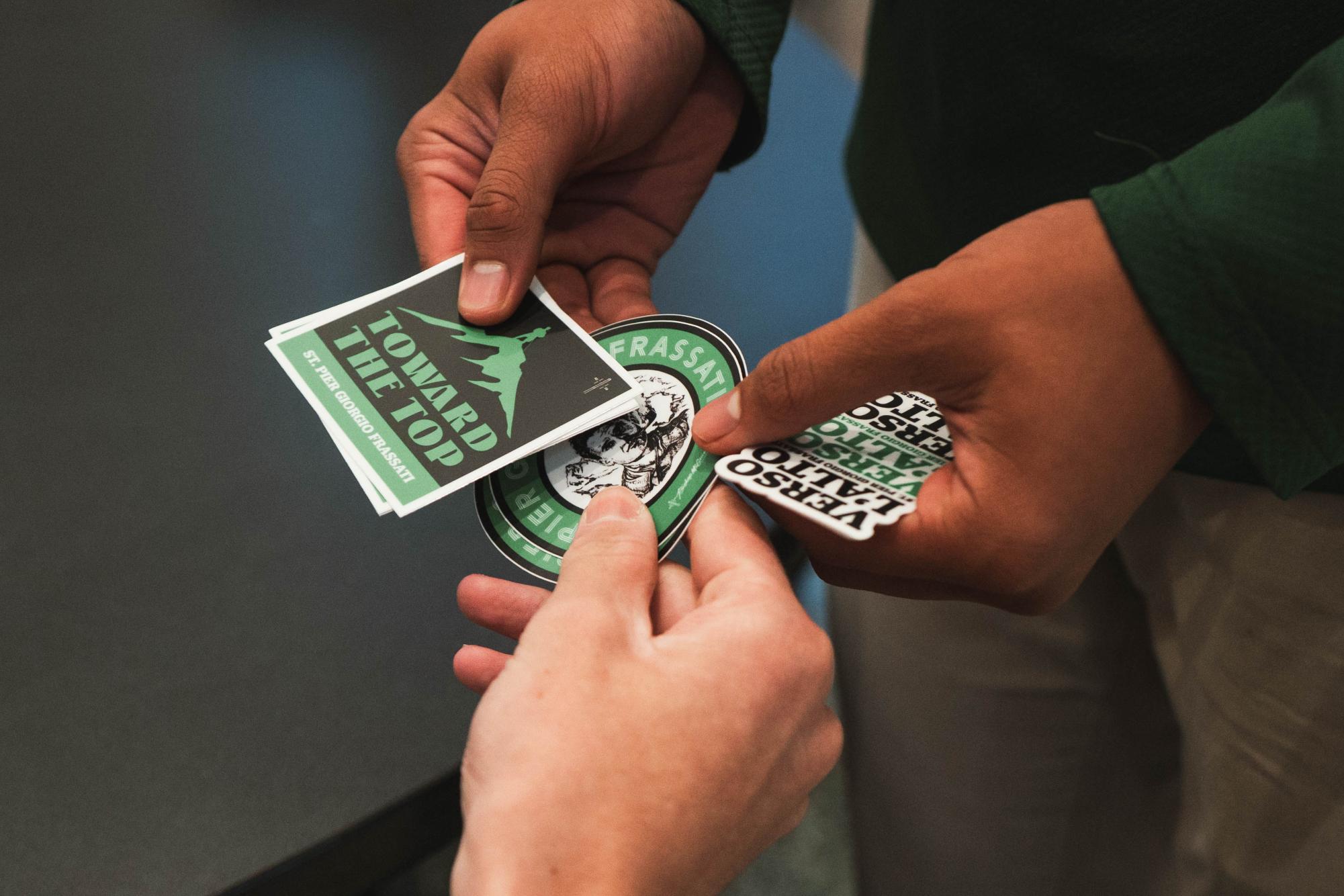 Stickers are distributed in celebration of Saint Pier Giorgio Frassati's canonization.