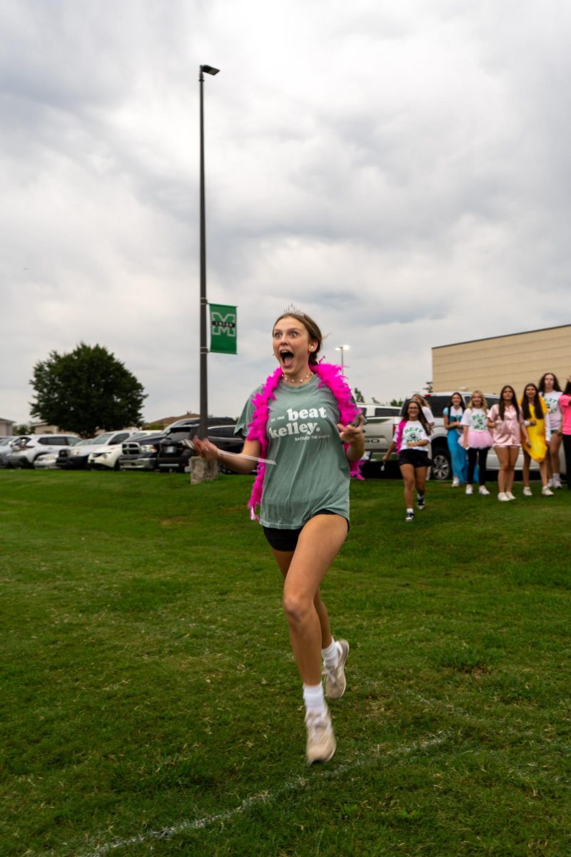 Freshman girl runs to find her 'big' partner on September 5th, 2025. 