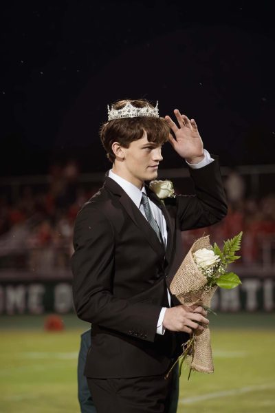 Senior Seth Lucky adjusts his crown after becoming the first homecoming king in school history.