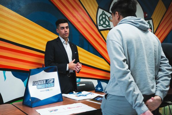 Senior engages with Thunder representative to learn more about his career path   