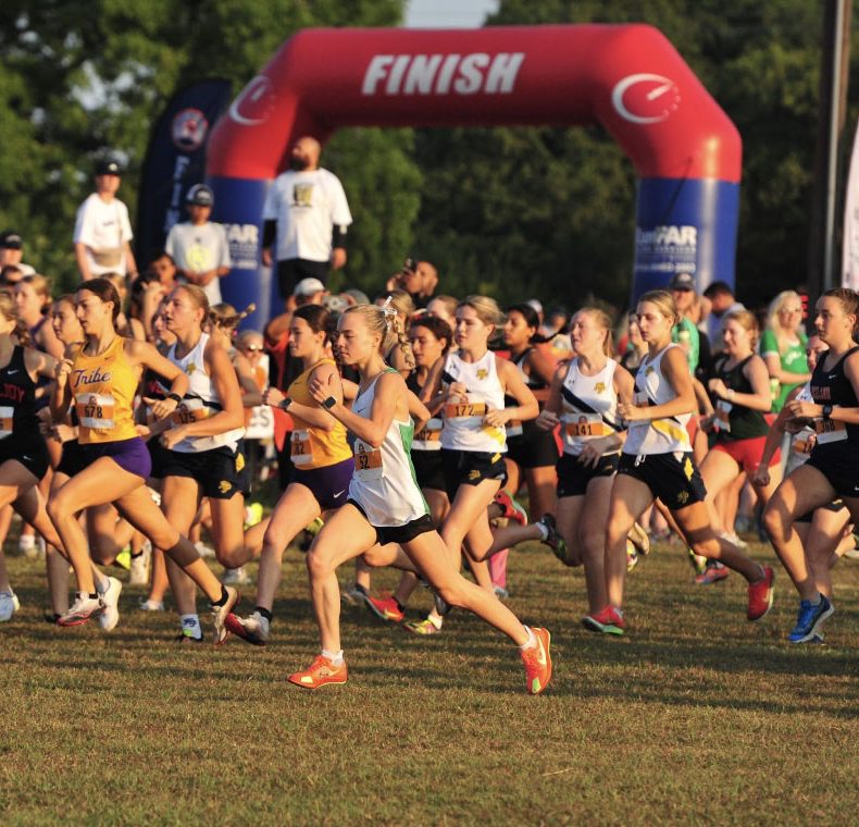 Sophomore Sylvie Harper (center) runs in the LoveJoy Cross-Country Festival.