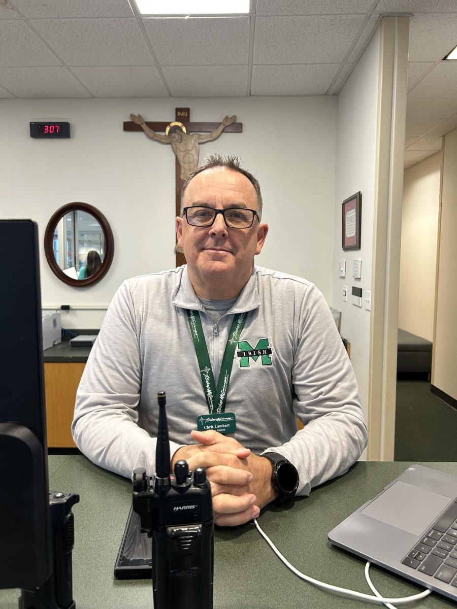 School Safety Liaison Chris Lambert sits for photo at front office.