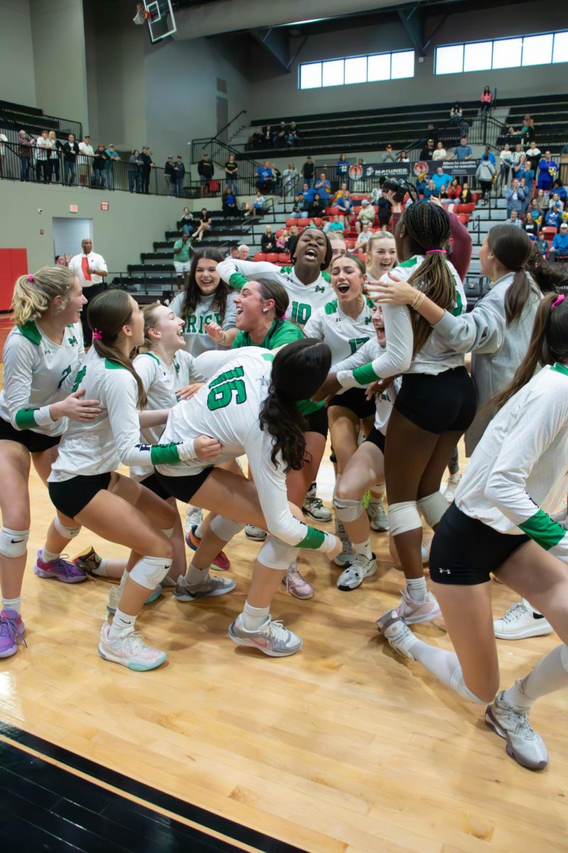 The team celebrates after the winning set point of the state final.