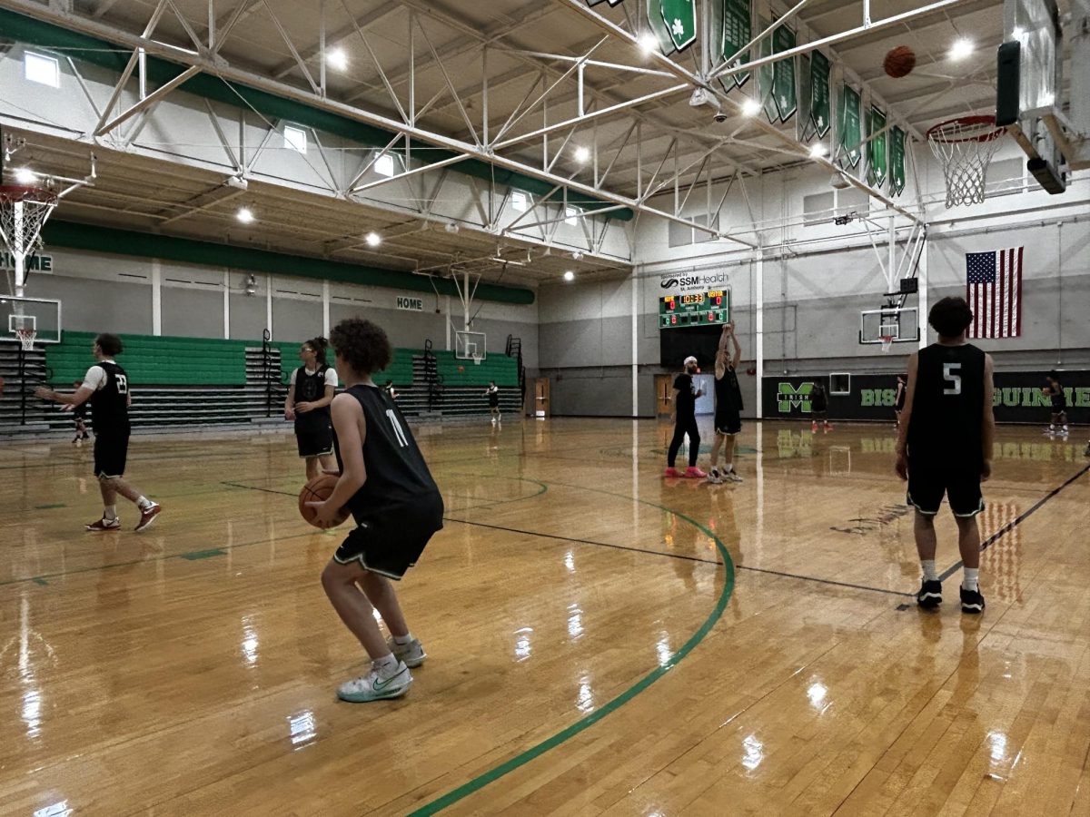 Boys basketball team warms up for practice.