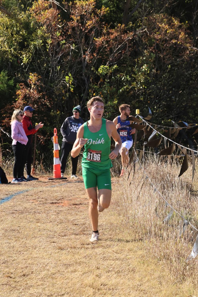 Senior Luke Worthington rounds a corner at the 5A State Cross-country Tournament.