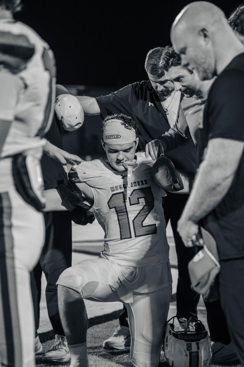 Senior Andrew Harris kneels during game against Midwest City.
