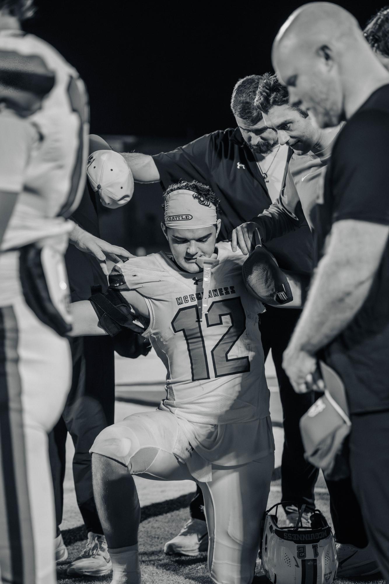 Senior Andrew Harris kneels during game against Midwest City.