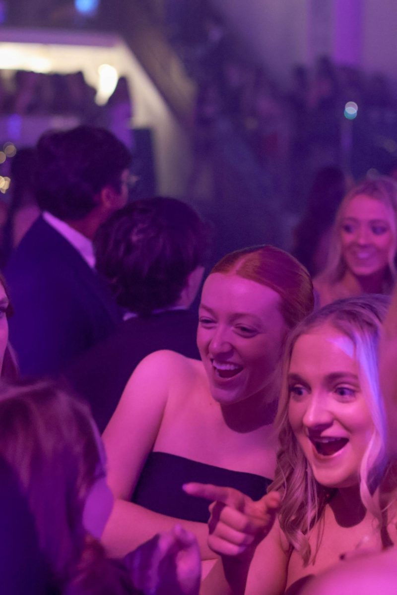 Junior Finley Cataldi and Senior Addy McCoy laugh on the dance floor.