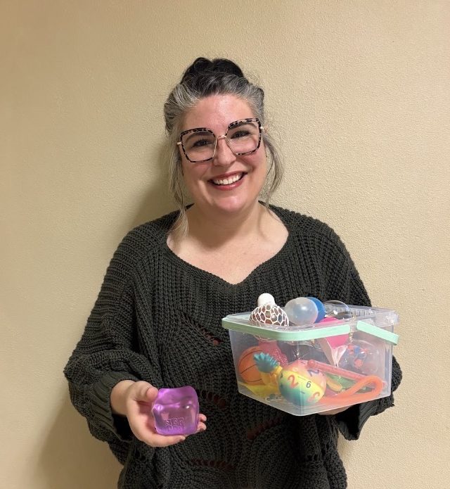 English teacher Rebecca Savuto displays her bin of fidgets. Savuto is a fan of fidgets as long as they do not disrupt the learning environment. 


