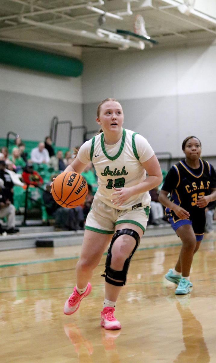 Junior Abby Elder dribbles toward the basket during Classen S.A.S. Dec. 2.