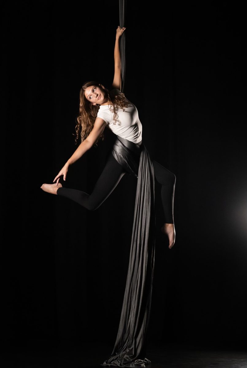 Junior Sarah Dickerson hangs from a silk. Photo courtesy of Sarah Dickerson