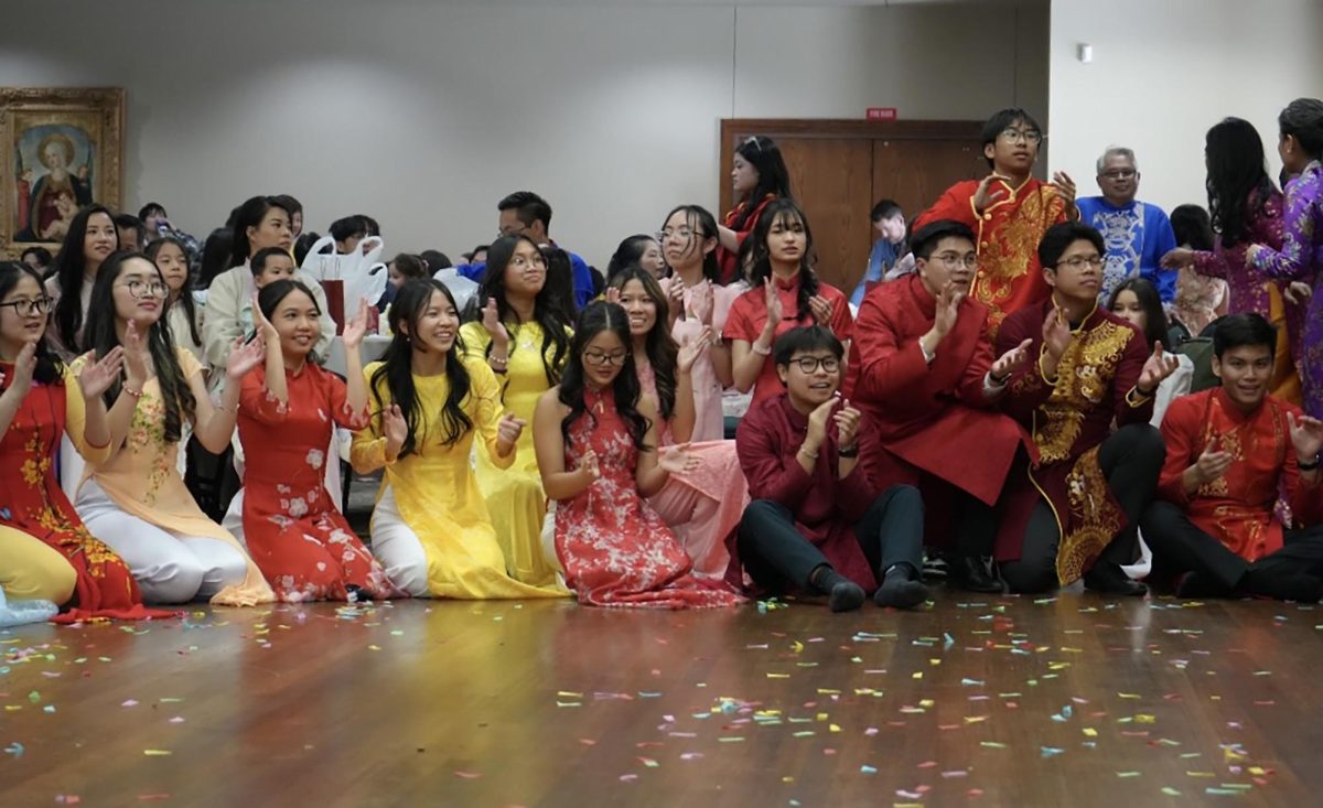 Students applaud a Vietnamese singer’s performance.